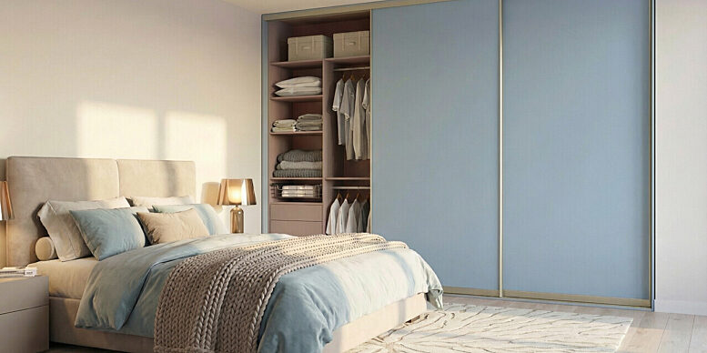 Niebieska szafa przesuwna wnekowa w sypialni z lozkiem