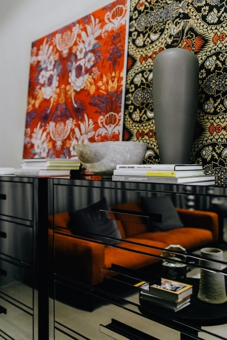 Kaboompics Books and decorations on a mirrored commode